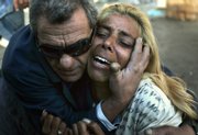An Israeli woman is comforted by a friend at the site of a suicide bombing that killed three people in the southern city of Eilat, Israel. A Palestinian suicide bomber attacked a bakery Monday in the resort town, police said; it was the first suicide bombing in Israel in nine months and the first ever to hit Eilat, Israel's southernmost city.