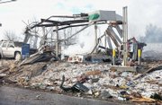 Debris litters the scene of an explosion at a gas station in Ghent, W.Va. Fumes from a leaking propane tank exploded inside the station on Tuesday, shattering the building into a pile of debris and killing at least four people, authorities said.