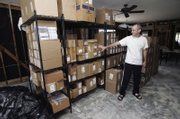 Mark Samuels, who runs his business from his home, points to his inventory on temporary shelves in his office in New Orleans in this file photo. Samuels, president and founder of New Orleans-based Basin Street Records, is haggling with ICF's Road Home aid program over the amount of compensation he is due.