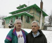 Delores and Ivan Eicher are shown in front of their Omaha, Neb., home. The Eichers were part of a lawsuit with 12 other Omaha area homeowners who alleged that Mid-America Financial Investment Corp. had defrauded them when they thought the company would help them pay their mortgages.