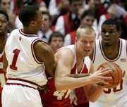 indiana guard armon bassett, left, and Wisconsin's Joe Krabbenhoft battle for a loose ball during the first half. Indiana beat Wisconsin, 71-66, Wednesday in Bloomington, Ind.