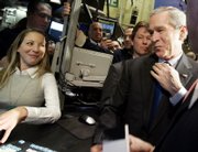 President Bush makes an unannounced visit Wednesday to the New York Stock Exchange and meets trading assistant Jennifer Fagenson at the post that trades the Walt Disney Co. Bush became the second president to visit during trading hours.