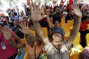 Hundreds of supporters of Venezuela's President Hugo Chavez raise their hands at the Plaza Bolivar in Caracas. They gathered Wednesday as lawmakers read out a bill giving Chavez special powers to enact a wide range of reforms.