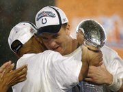 Indianapolis quarterback Peyton Manning, right, hugs coach Tony Dungy as they hold the Lombardi Trophy. Manning was named MVP of the Colts' 29-17 Super Bowl victory against the Bears on Sunday in Miami.