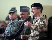Afghan President Hamid Karzai, center, shares a moment with outgoing commander of NATO-led International Security Assistance Force British Gen. David Richards, right, as new commander U.S. Gen. Dan McNeill, left, looks on during a change of command ceremony Sunday in Kabul, Afghanistan. McNeill replaces Richards at the helm of the 35,500-strong force as the Western alliance braces for a renewed fight with resurgent Taliban militants.