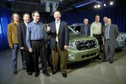 Alan Mulally, president and chief executive officer of Ford Motor Co., center, gives a thumbs-up to the crowd during a visit in January to the Kansas City Assembly Plant to celebrate production of the 2008 Ford Escape and the Mercury Mariner. Mulally plans to visit Lawrence next month to serve as grand marshal for the city's St. Patrick's Day Parade.