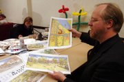 Dill Dennis, design team leader for MFMFM, shows off designs for the city library among other buildings and residential areas around Lawrence on Tuesday afternoon at Spring Hill Suites, 1 Riverfront Plaza. A team of designers has been working on the plans and sketches for the last week.