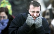 A hatless morning commuter attempts to keep warm as he walks to work in Chicago. The Upper Midwest is caught in a sub-zero weather pattern that is creating wind chills of 20 below around Chicago.