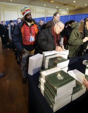 People line up to pick up copies of the fiscal 2008 federal budget at the Government Printing Office in Washington, D.C. President Bush released his $2.9 trillion budget for fiscal 2008 on Monday.