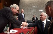 Senate Armed Services Committee Chairman Sen. Carl Levin, D-Mich., left, greets Defense Secretary Robert Gates on Capitol Hill prior to the committee's hearing on funding for the war in Iraq. Joint Chiefs Chairman Gen. Peter Pace, at right, also took part in the hearing on Tuesday.