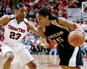 BAYLOR&squot;S JHASMIN PLAYER drives to the basket against Texas Tech&squot;s LaVonda "Tiny" Henderson during the second half. Player scored a career-high 22 points Wednesday night in the Bears&squot; 80-67 victory in Lubbock, Texas.