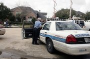 A Houston police officer stands watch outside the Houston home of astronaut Lisa Nowak. Nowak returned Wednesday to Texas and Johnson Space Center for a medical assessment a day after being charged in Florida with trying to murder the woman she believed was her romantic rival for a space shuttle pilot's affections.