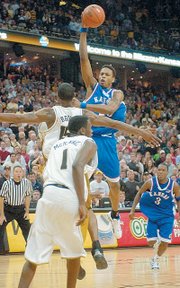 Kansas University guard Brandon Rush looks to dish as he drives against Missouri forward Marshall Brown in the second half of the Jayhawks' loss at Missouri. Rush had 14 points in that 89-86 setback in Columbia, Mo.