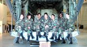 Lansing High School graduates Nicole Holland, third from left, Jessie Mitchum, center, and Angel Constantino, third from right, are pictured with classmates at their Traffic Management School in San Antonio. The three self-proclaimed "girly girls" signed up for the Kansas Air National Guard in March 2006 and have since completed basic training, which they said was a transforming experience.