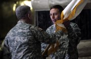 Gen. David Petraeus, right, takes the flag from Gen. John Abizaid, to become U.S. commander in Iraq Saturday in Baghdad. Petraeus took over from Gen. George Casey, who will become the next U.S. Army chief of staff.