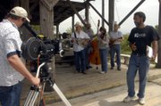 Between sets while filming "Bunker Hill," director Kevin Willmott, right, talks over a scene with teachers from the Americana Music Academy last August outside Lawrence. Kansas lawmakers this week will consider proposals aimed at providing flimmakers with tax breaks for filming movies in Kansas.