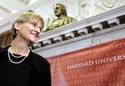 Newly appointed President of Harvard University Drew Gilpin Faust stands beneath a bust of university founder John Harvard after a news conference Sunday in Cambridge, Mass. Faust had been dean of Harvard's Radcliffe Institute for Advanced Study since 2001.