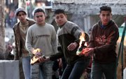 Palestinians throw Molotov cocktails at Israeli border police officers during clashes in the West Bank city of Hebron. Palestinians clashed Sunday with Israeli police in Jerusalem and the West Bank in a new wave of protests against ongoing Israeli construction near Jerusalem's Old City holy site.