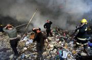 Iraqis grieve amid the rubble after a double car bomb attack in Baghdad, Iraq. A series of explosions tore through two downtown markets Monday, killing at least 78 people and wounding 160 in the latest act of carnage to strike the commercial center of the capital.