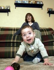 Connor Geddes, 11 months, has adapted well after receiving a mismatched heart transplant last March. He's shown at home in Erie, Pa., with his mom, Carrie.