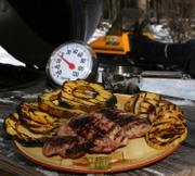 Grilled pork chops with squash, apples and cider-bourbon jus from Karen Adler and Judith Fertig's "Weeknight Grilling with the BBQ Queens" is perfect for those who can't go without grilling during a long winter.