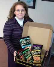 Lansing resident Stacy Cook shows off the box of Stacy's pita chip snacks that was delivered to her just days before her birthday. She later learned that she was a recipient in a nationwide marketing blitz by Stacy's in which the chips were sent to people named Stacy.