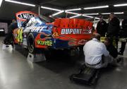 NASCAR officials inspect the car of driver Jeff Gordon in the Grand National Garage. The vehicle failed postrace inspection Thursday in Daytona Beach, Fla., and he will start the Daytona 500 in 42nd position.