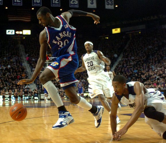 Kansas forward Julian Wright chases down a loose ball as Kansas State guard Clem Stewart watches from the floor in the second half.