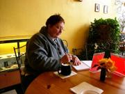 Kathy Jardon writing in her journal and visiting with friend who came in the Baldwin coffee shop, "Express Yourself." November, 2005.