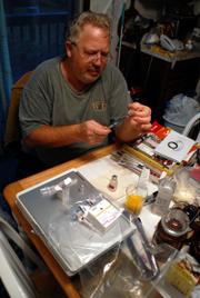 Kathy's final home care, besides visits from a hospice nurse, was pretty much in the hands of her former husband Miles Stotts and her daughter Sara. They worked in shifts. Here Miles, after talking to a nurse by phone, measures the pain medication diluted into a syringe.