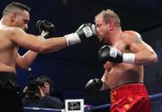 John Castle, left, throws a punch at Tommy Morrison. Morrison knocked out Castle on Thursday in Chester, W.Va.