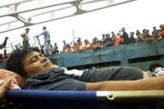 A victim of a ferry fire is taken off a cargo ship that rescued hundreds of passengers in Jakarta, Indonesia. A fire broke out Thursday on an Indonesian ferry carrying 350 passengers, killing at least 16 people and sending scores of passengers jumping into the sea, officials said.