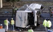 Rescue workers inspect the wreckage of a charter bus carrying the Bluffton University baseball team from Ohio after it plunged off a highway ramp in Atlanta and slammed into the pavement below. Six people on the bus were killed Friday, including the driver and his wife.