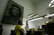 Lazaro Garcia, left, works at the Cohiba cigars factory Wednesday in Havana, Cuba. The ninth edition of the International Cigar Festival, attended by hundreds of cigar enthusiasts from Spain, Canada, Russia and 40 other countries, includes visits to plantations and cigar factories.