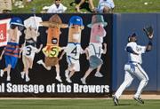 Milwaukee Brewers' Bill Hall catches a fly ball in a spring-training game againt San Francisco on Saturday. Hall is adjusting to life as an outfielder after spending most of his career in the infield.