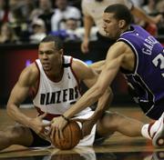 PORTLAND'S BRANDON ROY, LEFT, battles Sacramento's Francisco Garcia for a loose ball during Saturday's game. Roy is one of the favorites to win this season's Rookie of the Year award.