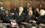 From left, Brown Chapel AME Church pastor James Jackson; Democratic presidential candidate Sen. Barack Obama, D-Ill.; Rep. John Lewis, D-Georgia; and the Rev. Clete Kiley hold hands and sing at the end of a church service, Sunday in Selma, Ala.