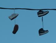 MORE pairs of shoes dangle from the power line near the intersection of 14th and Tennessee streets. Westar Energy spokeswoman Karla Olsen says the company doesn't make special trips to remove shoes from power lines unless they cause a power disruption.