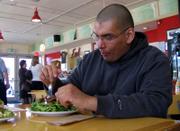 Daniel Fisher enjoys one of his favorite Local Burger dishes. "I&squot;m not really a salad guy, but I love that salad. I could eat it every day," says the former fast-food diner. For 30 days, Fisher gave up fast food and ate only at Local Burger, 714 Vt.