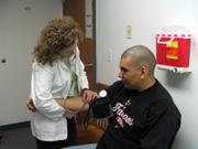 Mary Dooley, nurse at First Med, 2323 Ridge Court, gives Daniel Fisher some good news Monday. In addition to his blood pressure decreasing, Fisher's weight and cholesterol levels have also dropped significantly.