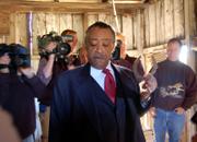 The Rev. Al Sharpton holds a horseshoe in a building that once housed some of his relatives on the grounds of an old plantation home in Edgefield County, S.C. Phillip White, at right, who now owns the home, on Monday gave Sharpton a horseshoe he found in the slave quarters on his property.