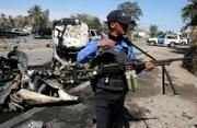 An Iraqi policeman stands in front of the wreckage of a car destroyed in a car bomb attack in west Baghdad, Iraq. The parked car exploded Tuesday in west Baghdad's Yarmouk area, targeting pilgrims en route to Karbala ahead of a Shiite Muslim holiday. Separate bombings in the southern town of Hillah killed more than 100 pilgrims.