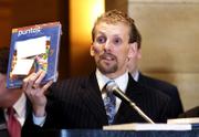 Scott Formo, president of the Minnesota State College Student Association, speaks Wednesday at the state Capitol at an event to spotlight rising textbook costs. Formo displayed a bundled set of Spanish materials that he said cost $193.