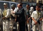 Iraqi Prime Minister Nouri al-Maliki shakes hands with an Iraqi army soldier in Baghdad, Iraq. Al-Maliki walked Baghdad's streets and visited police checkpoints Friday to showcase security ahead of a conference aimed at stabilizing the war-torn country with help from its neighbors.