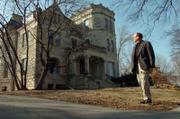 Architect Craig Patterson looks over the Castle Tea Room, 1307 Mass., which formerly housed a restaurant and was the site for many wedding receptions and other special events in the years before the death of owner "Libby" Kriz-Fiorito. Patterson serves on a foundation that hopes to restore the tea room to its former standing.