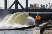 Daren J. Eller watches as pumps put in place by the Army Corps of Engineers pump water from New Orleans' 17th Street Canal to Lake Pontchartrain in New Orleans. One of the levees along the canal failed during Hurricane Katrina contributing heavily to the flooding of the city.