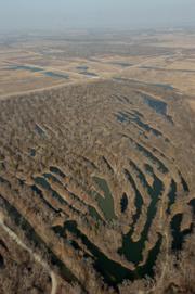 Surfacing mining for coal in the tri-state area contributed significantly to quench the nation's thirst for energy, but it also caused irreversible environmental damage. Above, strip mines reduce the land uses possibilities for this section of land near West Mineral, Ks.