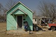 "I'm going nowhere," says Picher resident Jon Finn. "I'm staying here 'til I die." The State of Oklahoma is paying Picher residents to relocate from the town for health reasons. Finn, who earns a living constructing model mining derricks, lost both his father, William, and brother, Don, to tuberculosis caused by inhaling coal dust.