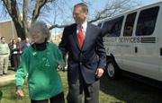 Lauraine Mulally, Lawrence, and her son, Ford Motor Co. CEO Alan Mulally, greet friends Friday at the Lawrence Senior Center. Alan Mulally presented a Ford van, right, to Douglas County Senior Services Inc. in honor of his mother. Alan Mulally will be the grand marshal in today's St. Patrick's Day Parade.