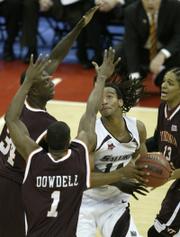 Southern Illinois forward Randal Falker, center, goes up against three Virginia Tech defenders. The Salukis eliminated the Hokies, 63-48, Sunday in Columbus, Ohio. SIU will play Kansas University on Thursday in San Jose, Calif.
